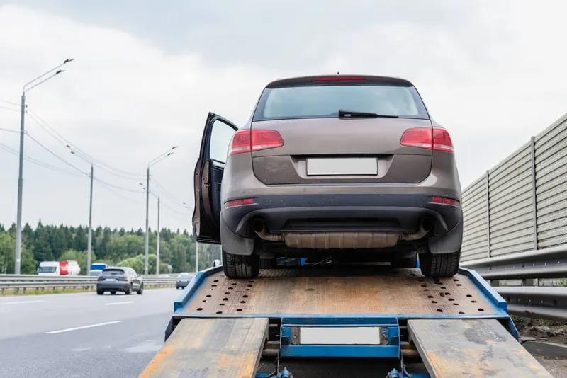 Vehicle secured on flatbed with ratchet straps